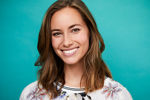 Image of woman smiling after dental implant related treatment by St. Louis Prosthodontics.