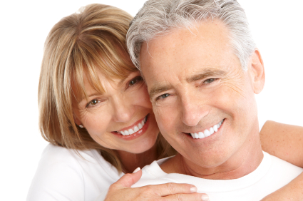 Older couple smiling after appointment at St. Louis Prosthodontics in St. Louis, MO