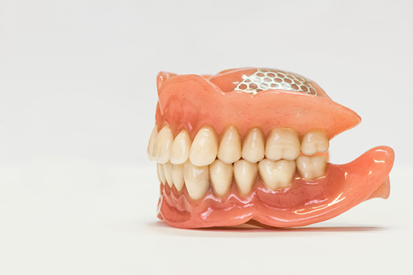 Set of full dentures on a white background